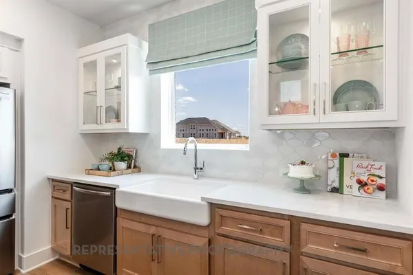a kitchen with a window a sink and cabinets