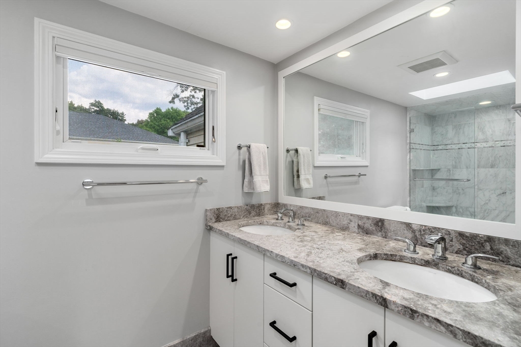 10 Strathmore Road Wellesley, MA 02482 - Photo 15 of 26 a bathroom with a granite countertop sink and a mirror