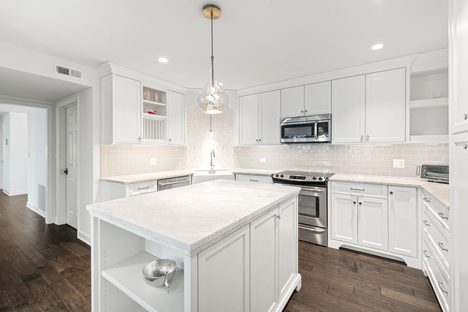 1409 Burr Oak Road, Unit 315A Hinsdale, IL 60521 - Photo 11 of 20 a kitchen with stainless steel appliances a stove sink microwave and cabinets