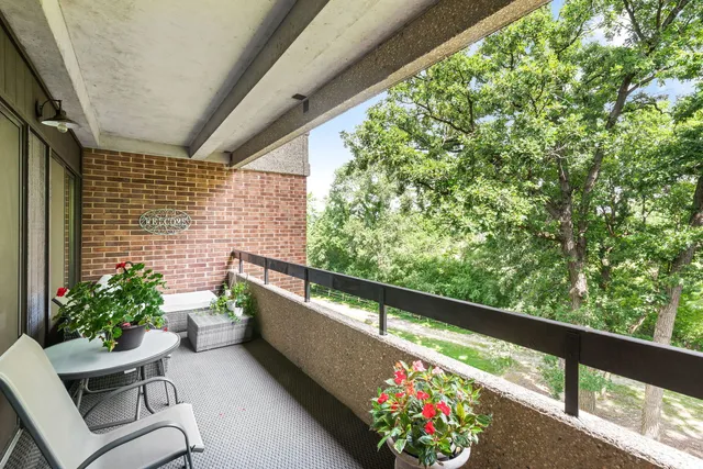 a view of a chairs and table in a balcony