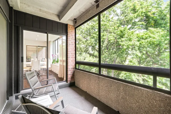 a view of a large room with wooden floor and windows