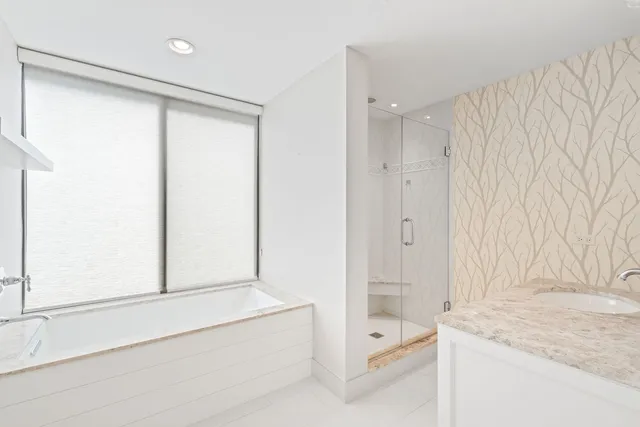 a bathroom with a shower and a tub