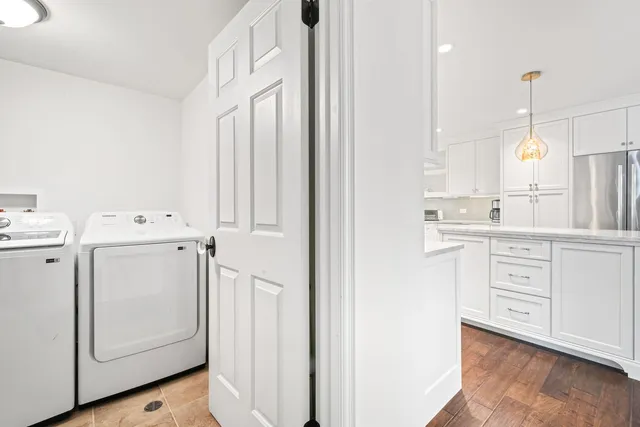a kitchen with white cabinets and white appliances