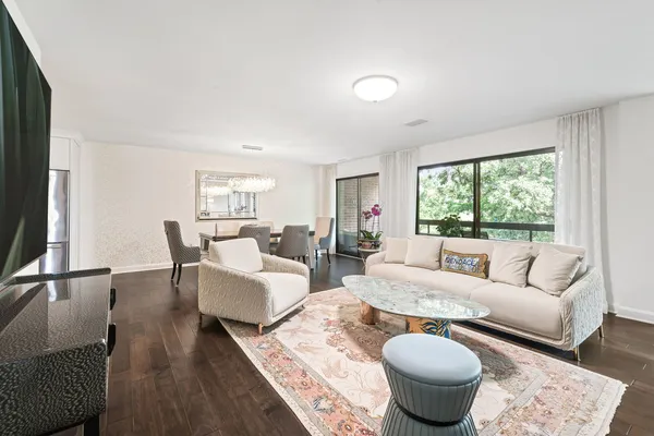 a living room with furniture a lamp and a table