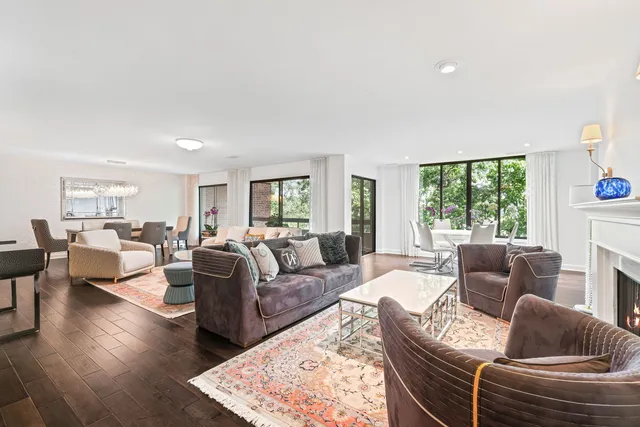 a living room with furniture wooden floor and a large window