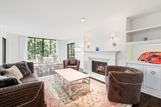 a living room with furniture fireplace and window