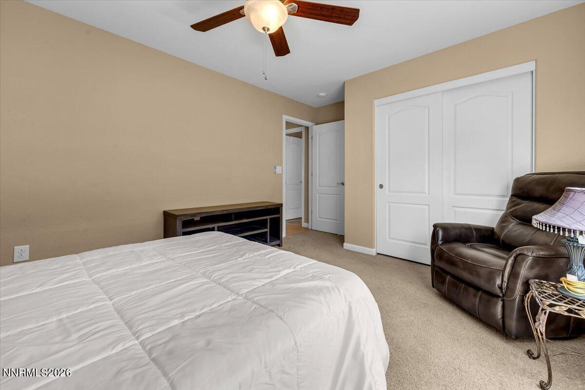 104 Bethpage Road Dayton, NV 89403 - Photo 31 of 65 a bedroom with a bed couch and a ceiling fan