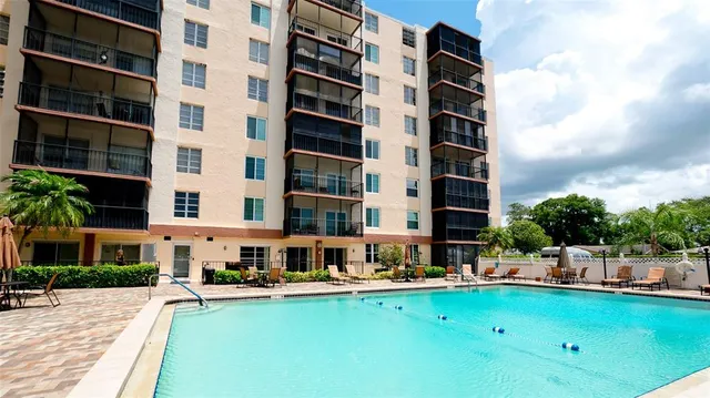 a swimming pool with buildings in the background