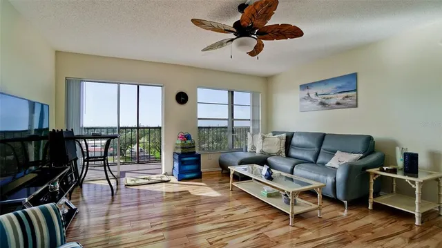 a living room with furniture and a floor to ceiling window