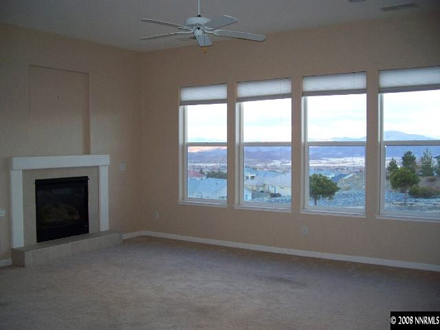 5585 North White Sands Road Reno, NV 89511 - Photo 2 of 9 a view of livingroom window and a fireplace
