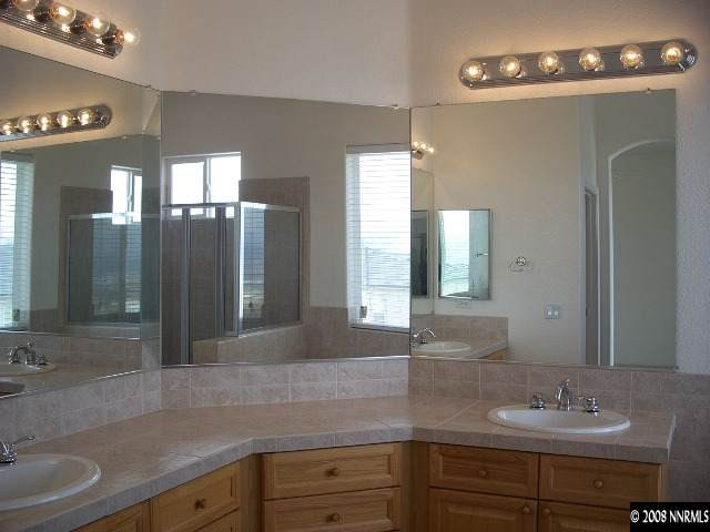 5585 North White Sands Road Reno, NV 89511 - Photo 7 of 9 a bathroom with a sink double vanity and a mirror