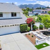 a view of a patio with table and chairs potted plants