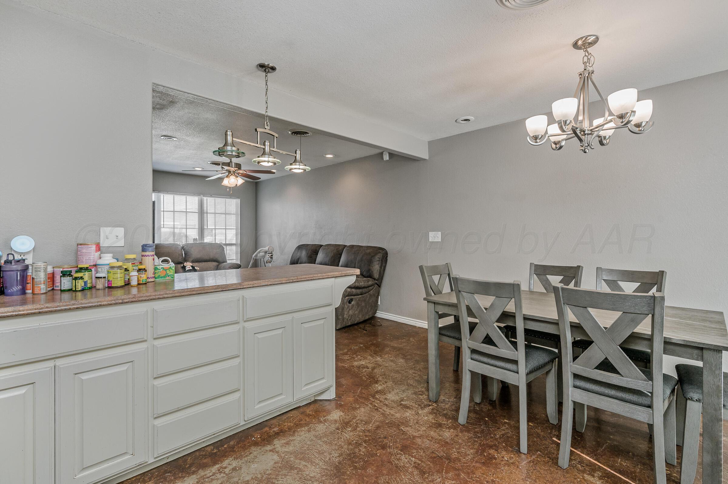 4351 South Tyler Street Amarillo, TX 79110 - Photo 8 of 18 a view of a dining room with furniture and chandelier