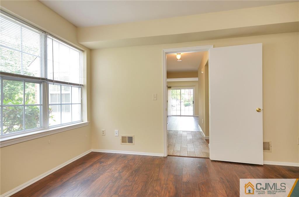 1401 Plymouth Road North Brunswick, NJ 08902 - Photo 14 of 25 an empty room with wooden floor and windows