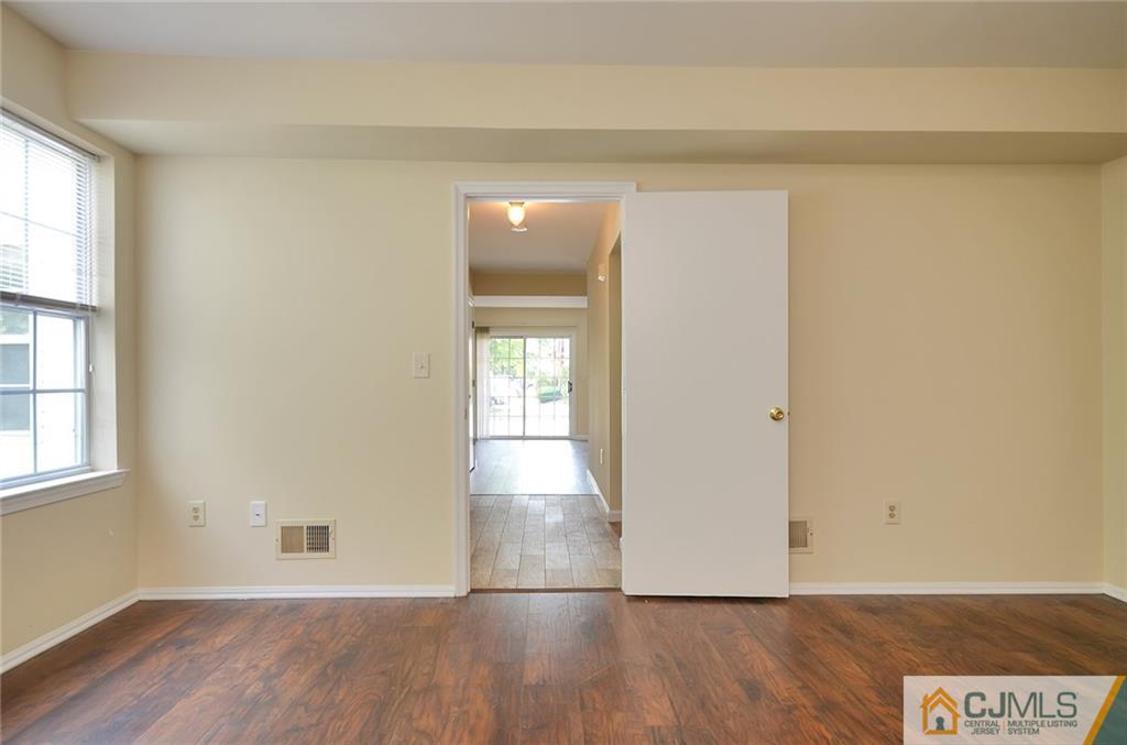 1401 Plymouth Road North Brunswick, NJ 08902 - Photo 17 of 25 an empty room with wooden floor and windows