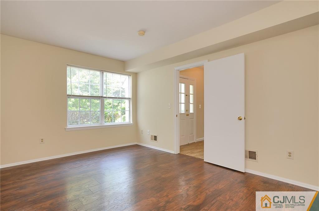 1401 Plymouth Road North Brunswick, NJ 08902 - Photo 18 of 25 an empty room with wooden floor and windows