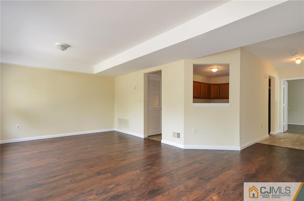 1401 Plymouth Road North Brunswick, NJ 08902 - Photo 7 of 25 a view of an empty room with wooden floor and a window