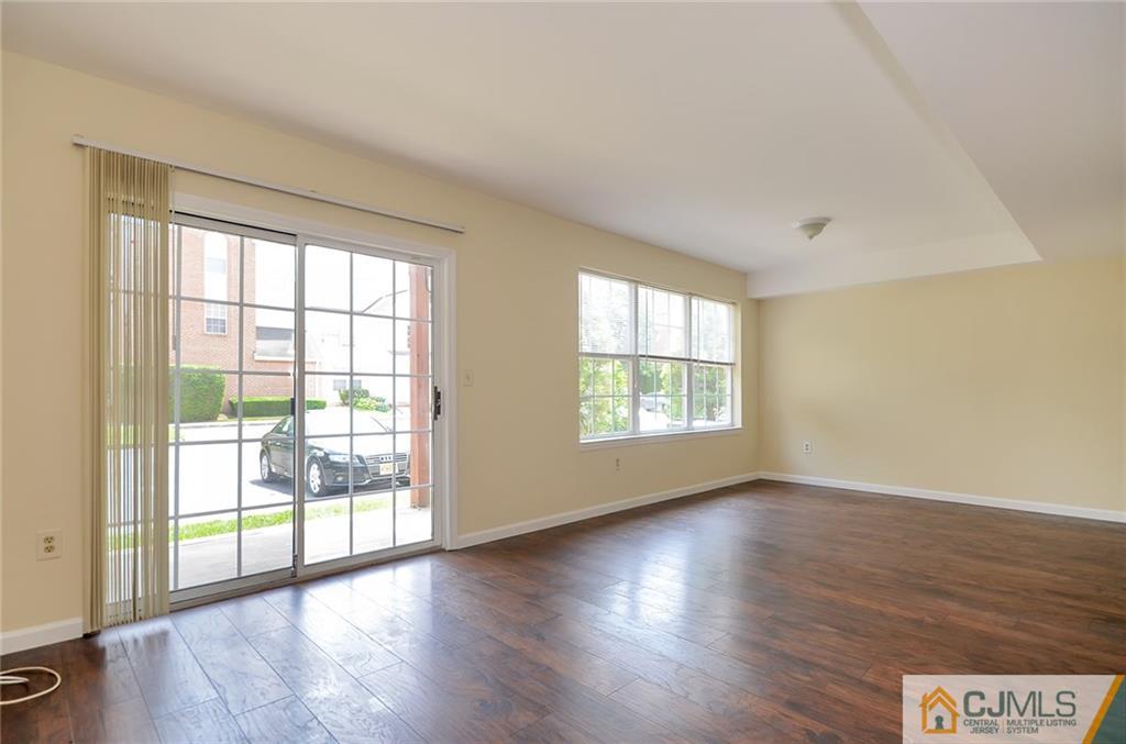 1401 Plymouth Road North Brunswick, NJ 08902 - Photo 8 of 25 an empty room with wooden floor and windows