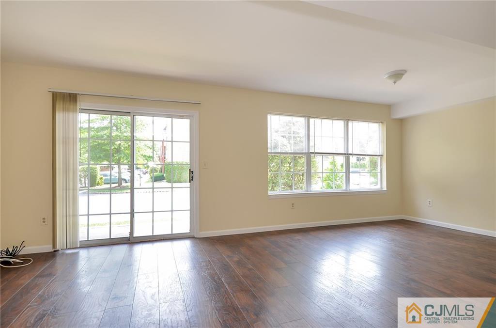 1401 Plymouth Road North Brunswick, NJ 08902 - Photo 10 of 25 a view of an empty room with wooden floor and a window