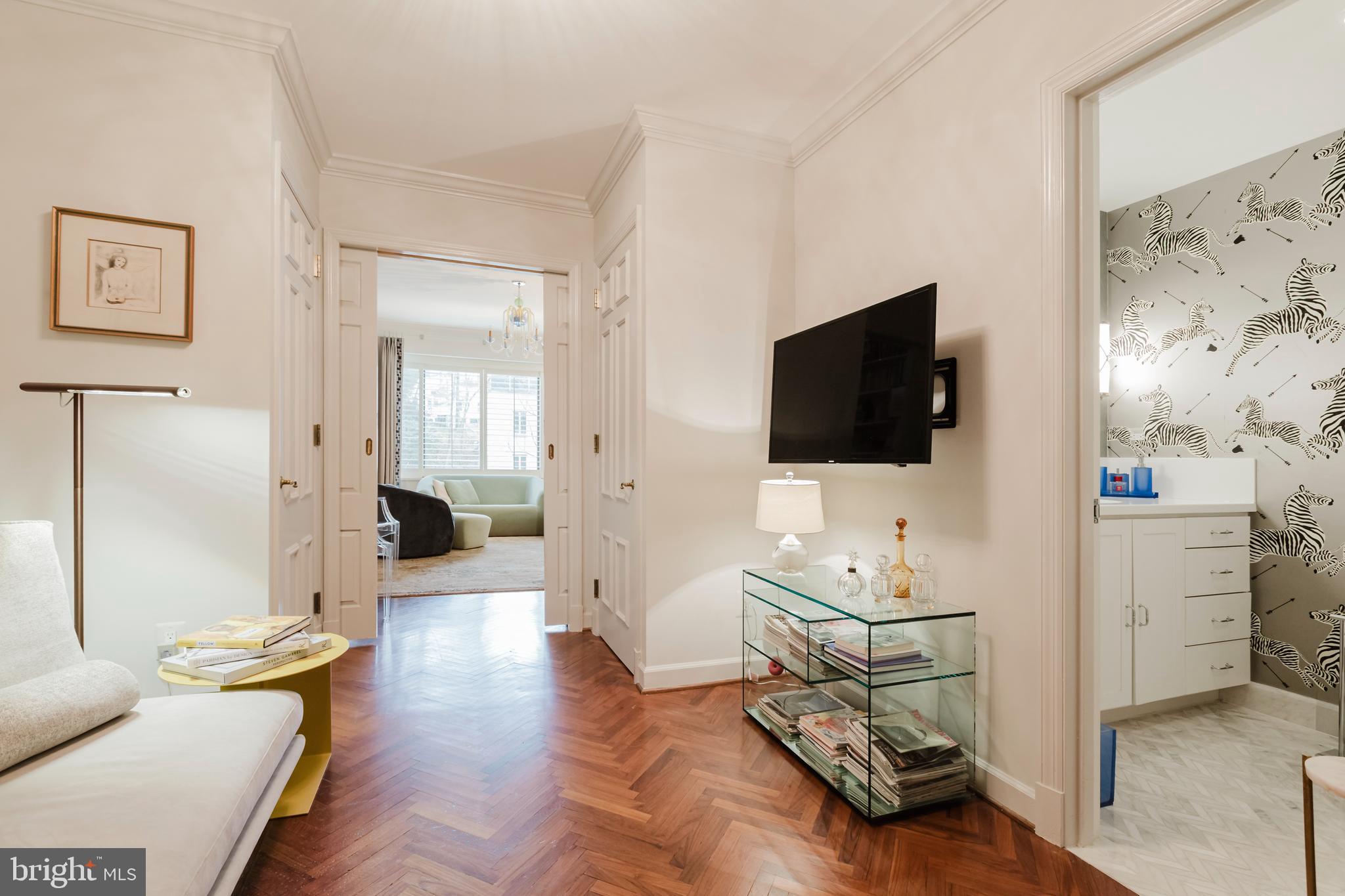 2700 Calvert Street Northwest, Unit 217 Washington, DC 20008 - Photo 12 of 36 a living room with furniture and a flat screen tv
