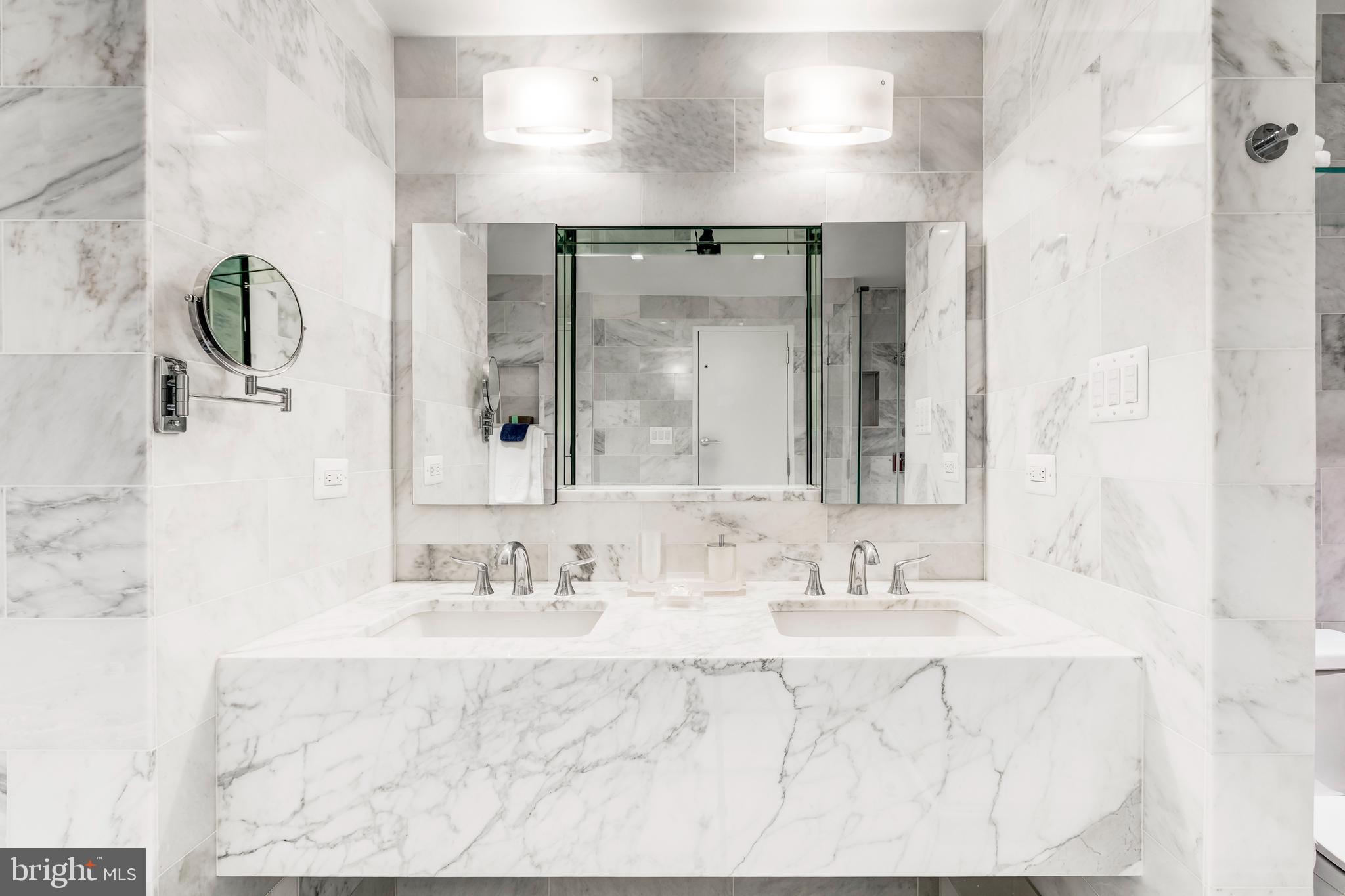 2700 Calvert Street Northwest, Unit 217 Washington, DC 20008 - Photo 20 of 36 a bathroom with a sink double vanity and a mirror