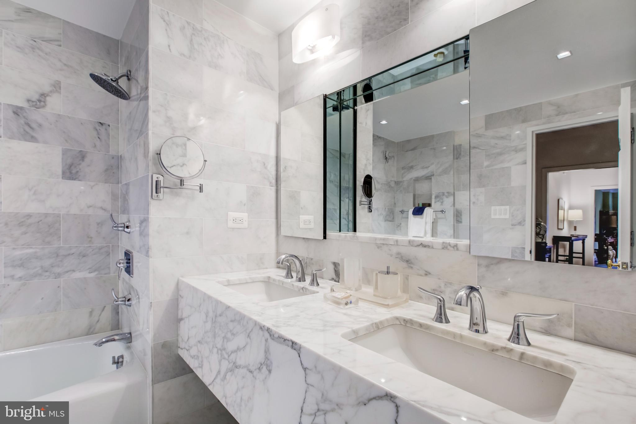 2700 Calvert Street Northwest, Unit 217 Washington, DC 20008 - Photo 21 of 36 a bathroom with a double vanity sink mirror double and shower