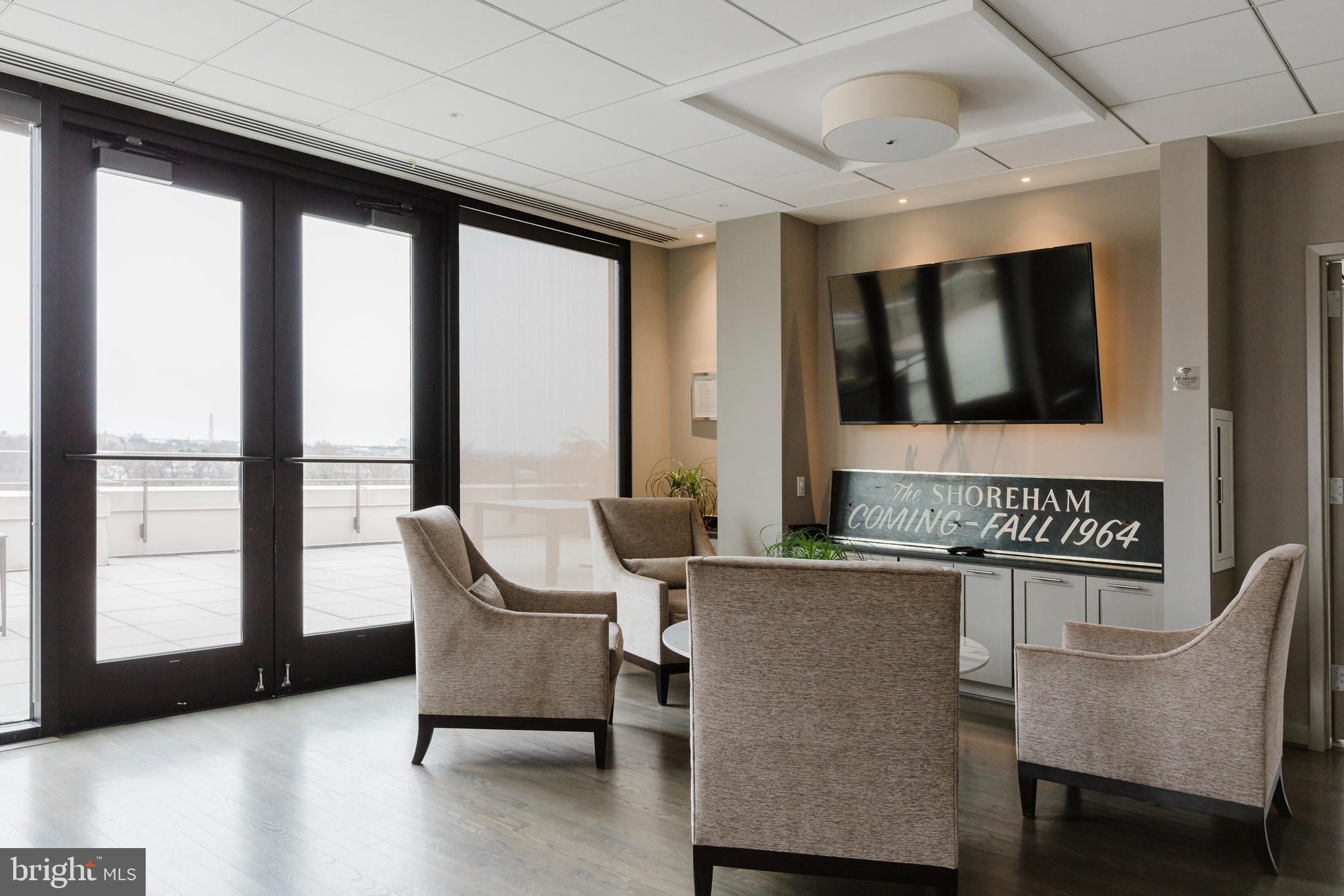 2700 Calvert Street Northwest, Unit 217 Washington, DC 20008 - Photo 31 of 36 a living room with furniture and a floor to ceiling window