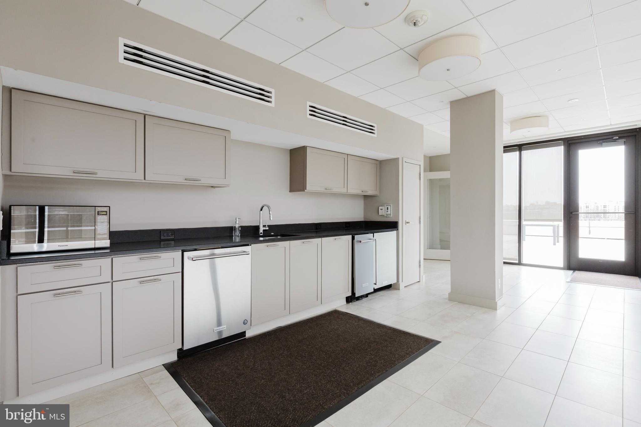 2700 Calvert Street Northwest, Unit 217 Washington, DC 20008 - Photo 33 of 36 a kitchen with stainless steel appliances granite countertop a sink stove and cabinets