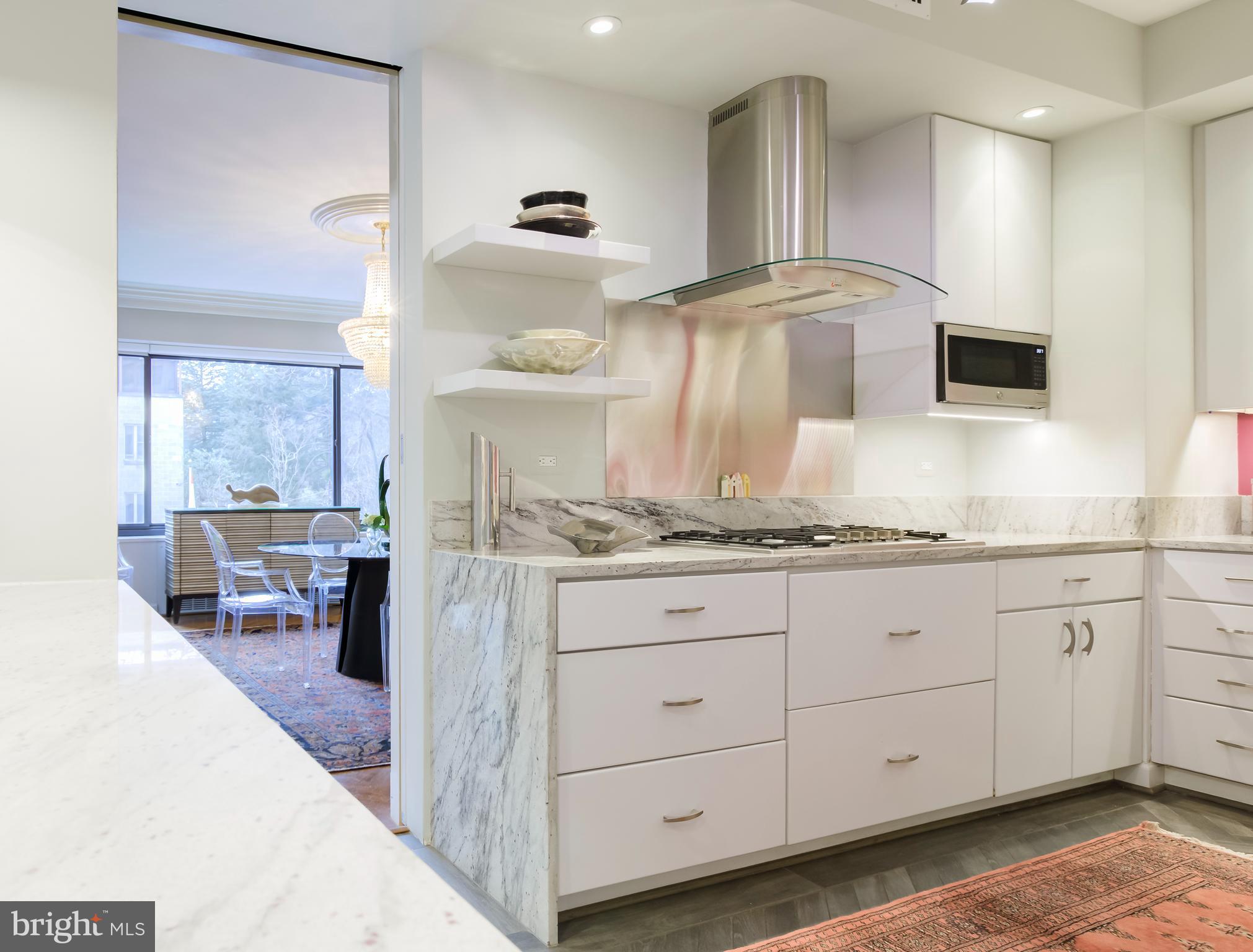 2700 Calvert Street Northwest, Unit 217 Washington, DC 20008 - Photo 5 of 36 a kitchen with granite countertop white cabinets and sink