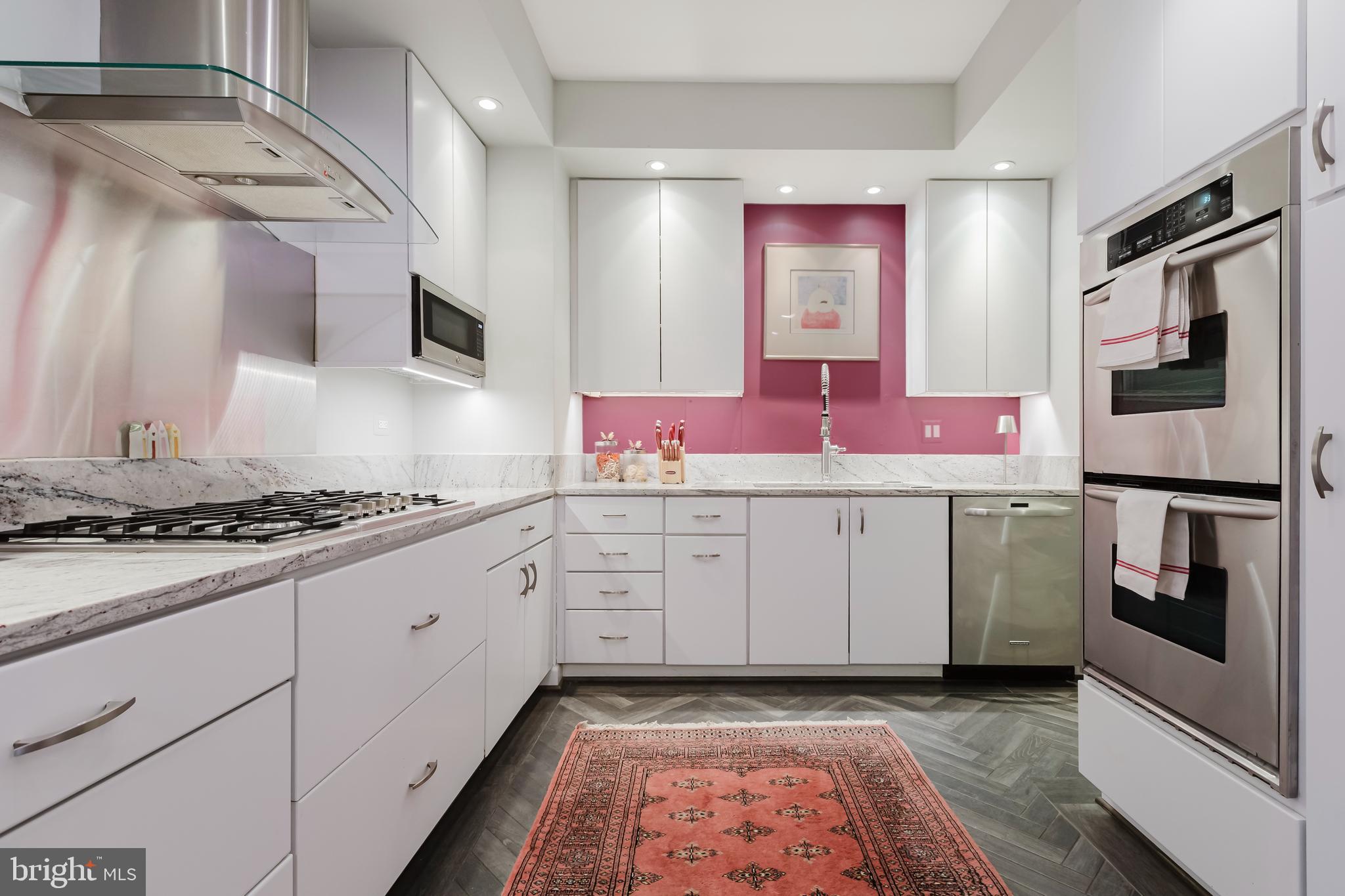 2700 Calvert Street Northwest, Unit 217 Washington, DC 20008 - Photo 6 of 36 a kitchen with cabinets and stainless steel appliances