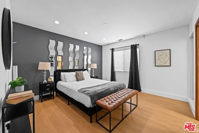 a living room with a bed furniture and a large window