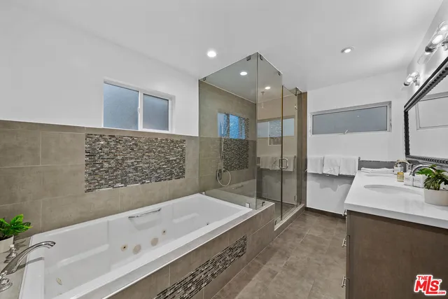 a bathroom with a bathtub and a sink