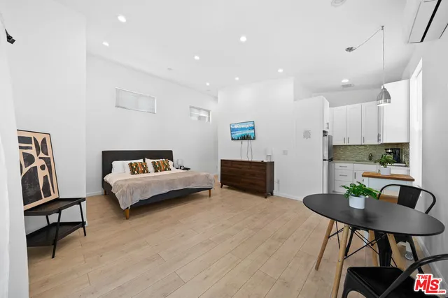 a living room with furniture a dining table and kitchen view
