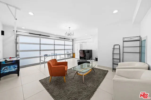 a living room with furniture a rug and a window