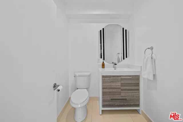 a bathroom with a sink toilet and mirror