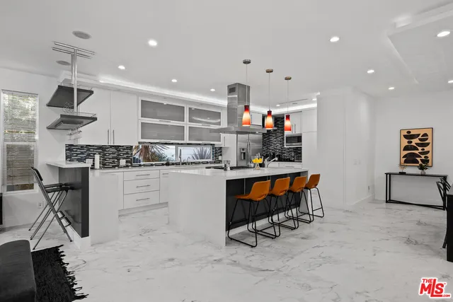 a kitchen with stainless steel appliances kitchen island granite countertop a sink and cabinets
