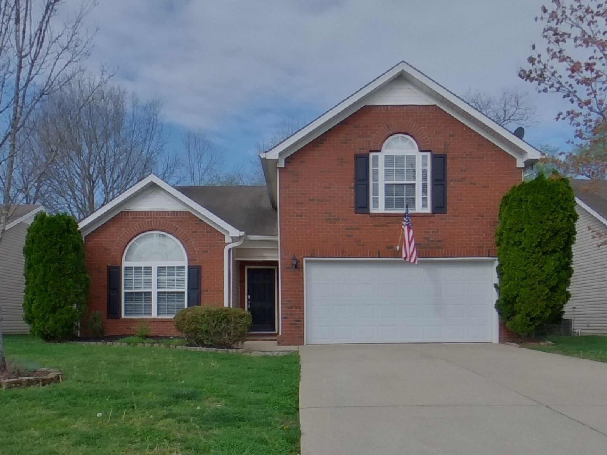 a front view of a house with a yard