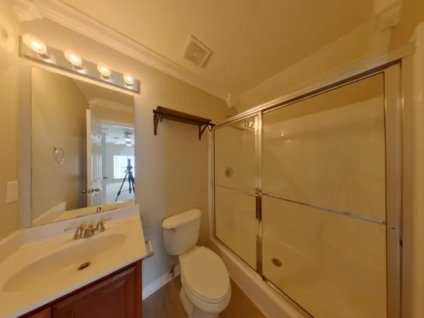 a bathroom with a sink mirror vanity and toilet