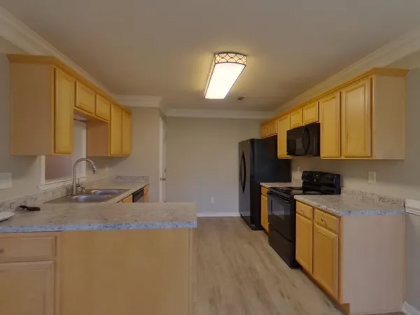a kitchen with stainless steel appliances granite countertop a sink stove and microwave