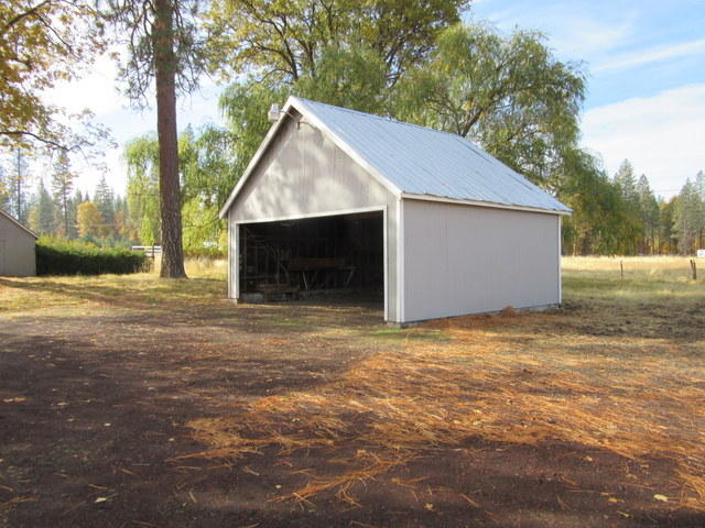 40905 Brown Road Fall River Mills, CA 96028 - Photo 11 of 24 a backyard of a house with garage and outdoor space