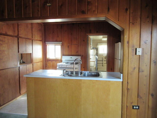 40905 Brown Road Fall River Mills, CA 96028 - Photo 17 of 24 a kitchen with stainless steel appliances granite countertop a sink a stove and a refrigerator with wooden cabinets