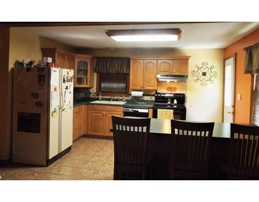 26 Corey Road Ashburnham, MA 01430 - Photo 2 of 8 a kitchen with stainless steel appliances kitchen island granite countertop a refrigerator and a stove top oven