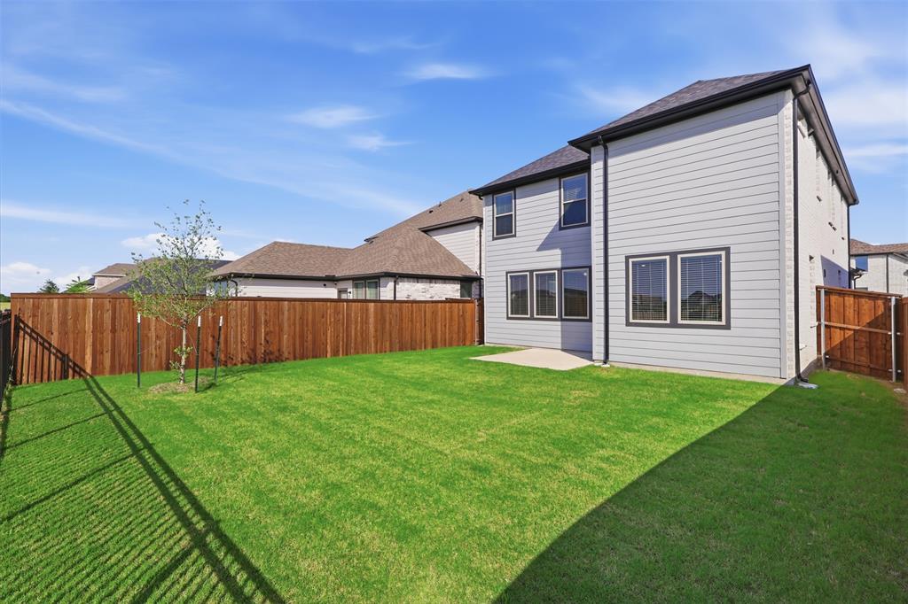 2629 Green River Road Royse City, TX 75189 - Photo 18 of 18 a view of a backyard with plants and wooden fence
