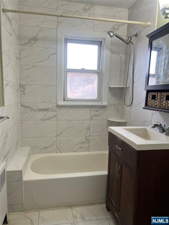 715 Broad Avenue, Unit 2A Ridgefield, NJ 07657 - Photo 12 of 12 a bathroom with a sink and a bathtub