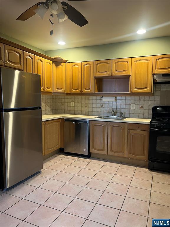 715 Broad Avenue, Unit 2A Ridgefield, NJ 07657 - Photo 2 of 12 a kitchen with stainless steel appliances granite countertop a refrigerator sink and cabinets