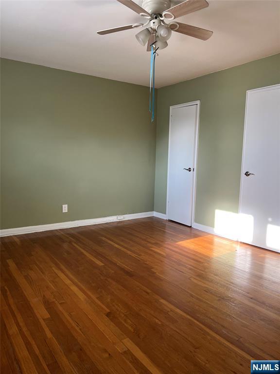715 Broad Avenue, Unit 2A Ridgefield, NJ 07657 - Photo 8 of 12 an empty room with wooden floor closet and fan