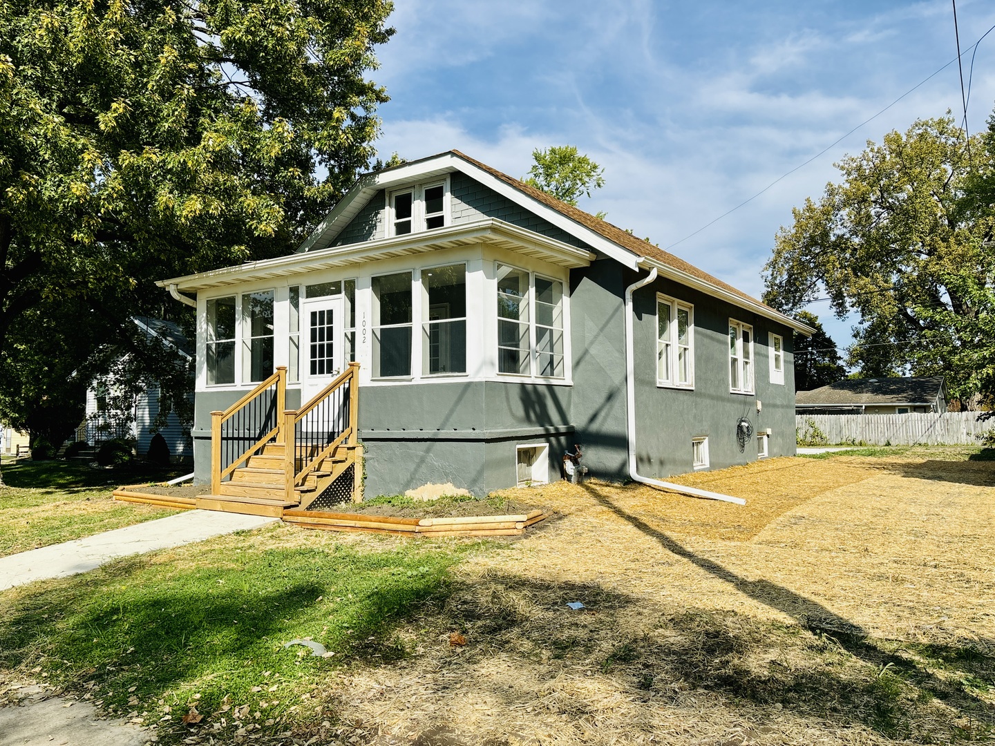 a view of a house with pool and chairs