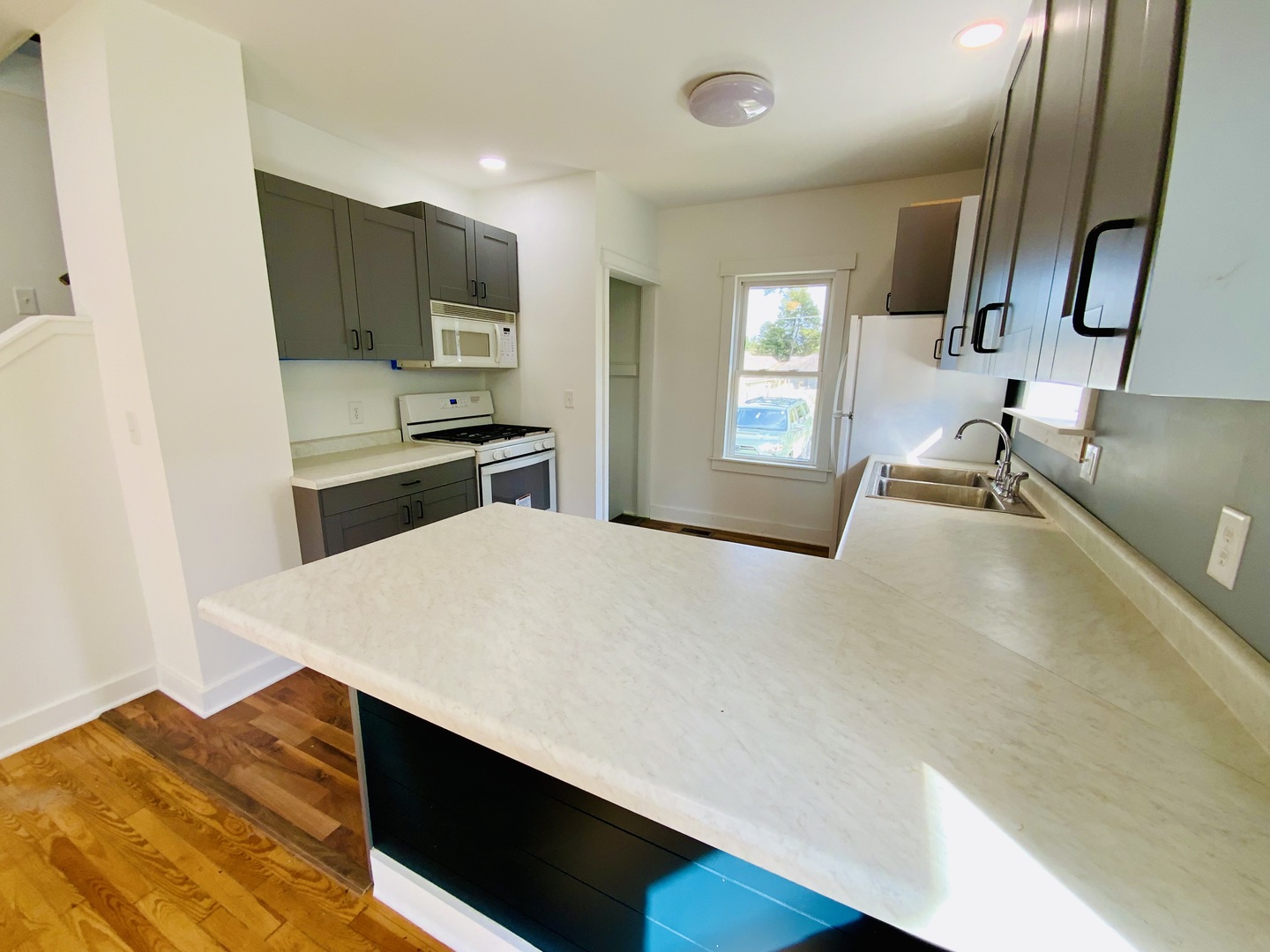 1002 Adams Street Ottawa, IL 61350 - Photo 6 of 14 a kitchen with stainless steel appliances a sink dishwasher stove refrigerator and microwave