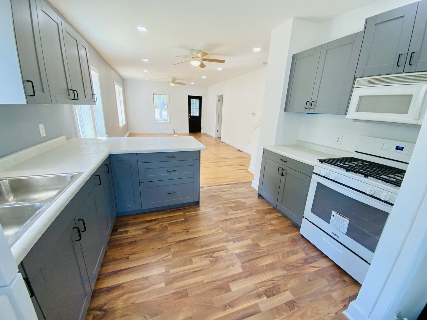 1002 Adams Street Ottawa, IL 61350 - Photo 7 of 14 a kitchen with wooden floors and a sink
