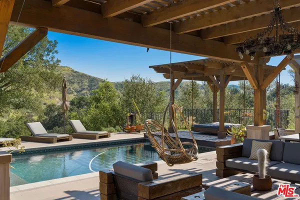 a view of swimming pool with outdoor seating